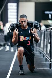 Dr. Kurren Sandhu doing a farmer's carry exercise